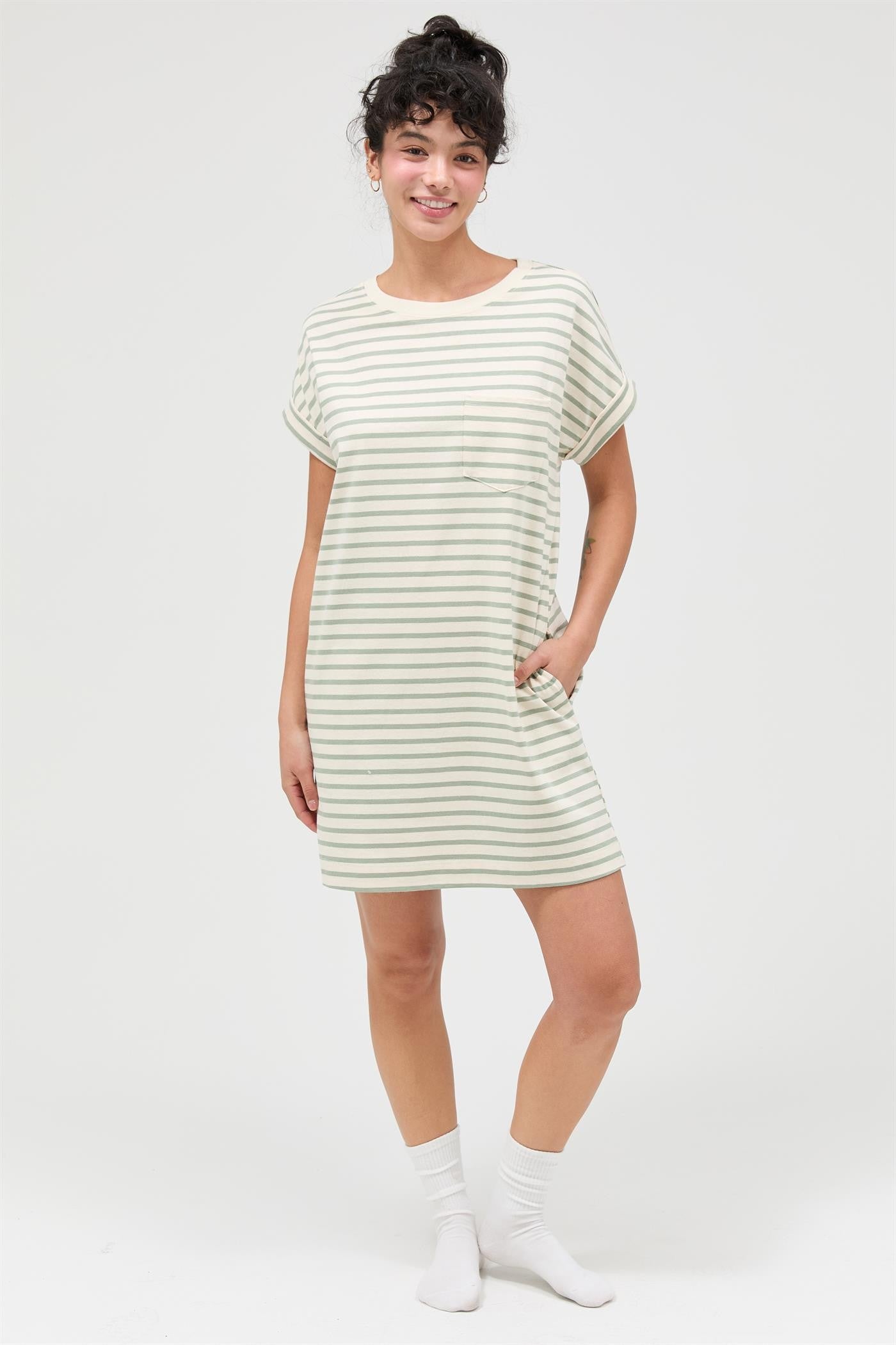 woman wearing a light green striped short sleeve dress with pockets and styled with white ankle socks