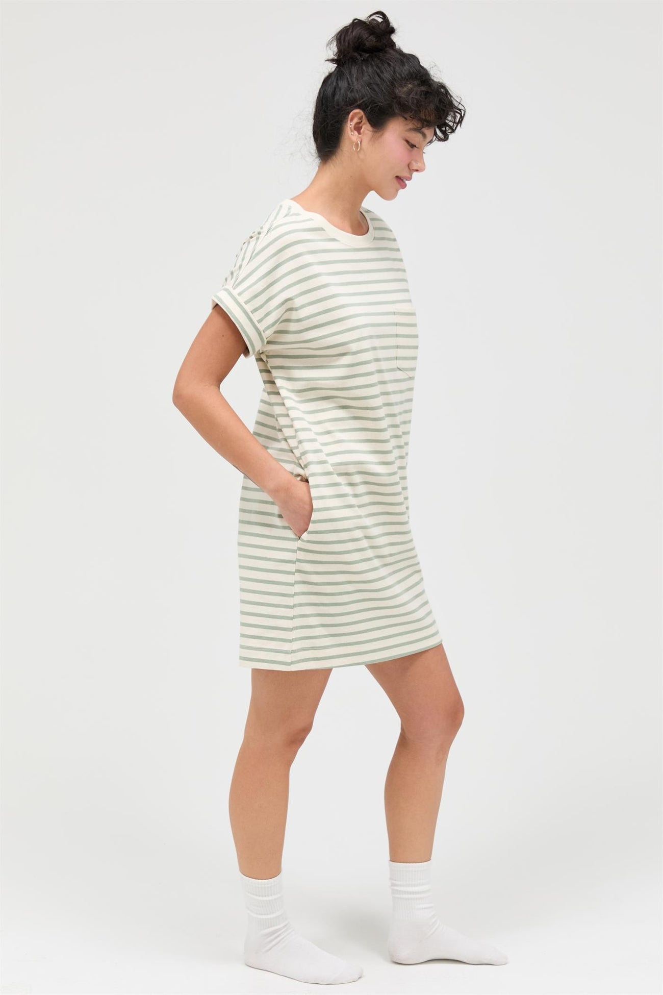 woman wearing a striped short sleeve dress with pockets in a relaxed fit and knee-length style