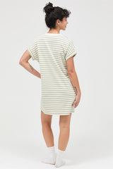 woman wearing a striped oversized t-shirt dress with rolled sleeves, facing away from the camera