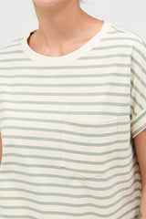 woman wearing a cream and green striped short sleeve top with a chest pocket