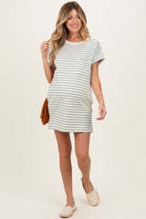 woman wearing a light gray and white striped maternity dress with a pocket and a baby bump visible