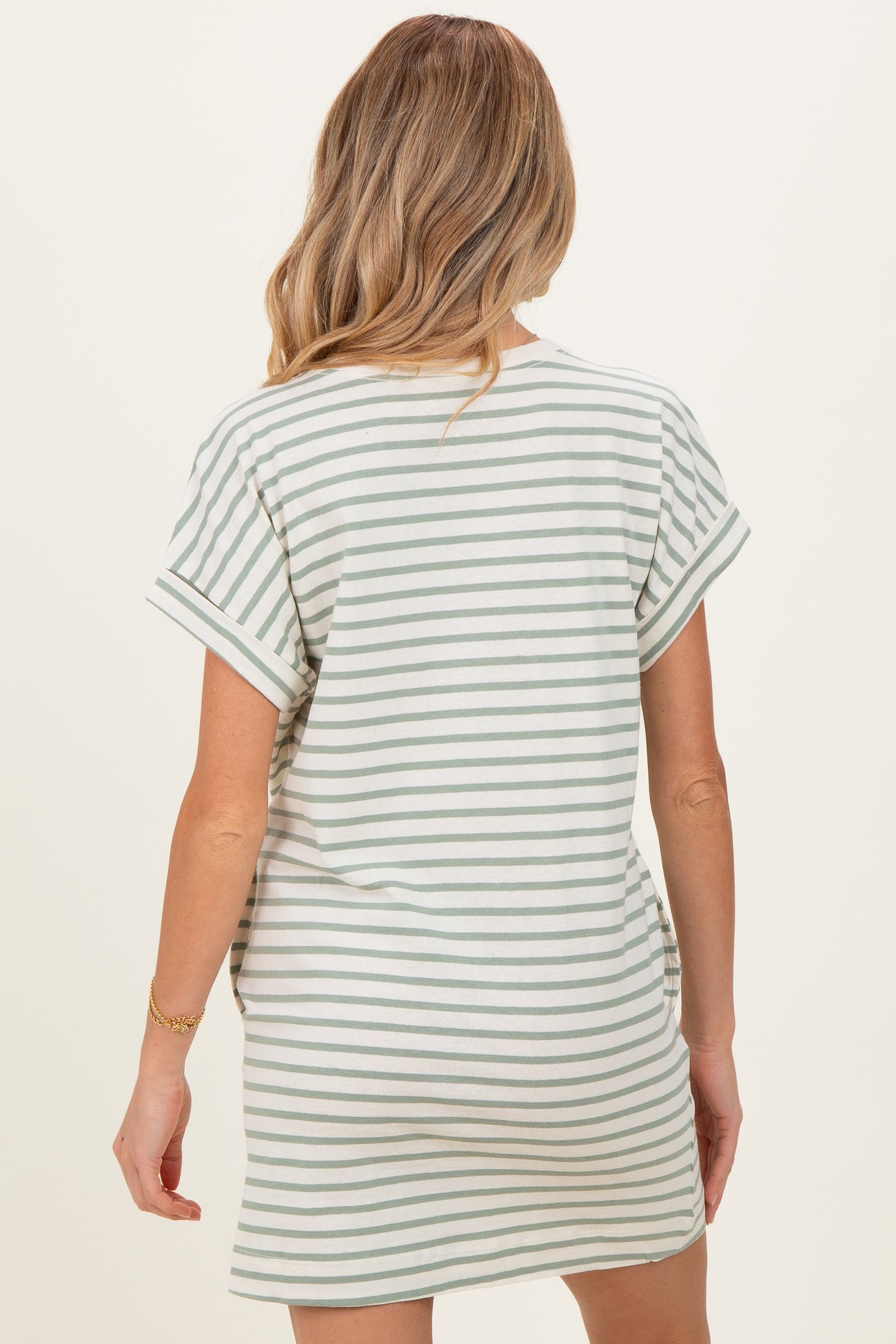 woman wearing a striped maternity dress with short sleeves, showing the back view