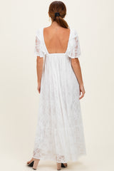 woman wearing a white lace maxi dress with a deep back and short sleeves, showing the back view