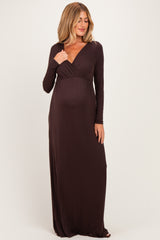 woman wearing a brown long sleeve maternity dress with a wrap style and a visible baby bump