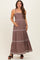 woman wearing a mauve maxi maternity dress with spaghetti straps and embroidered detailing, holding her baby bump