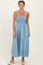 woman wearing a light blue smocked maxi dress with spaghetti straps and a relaxed fit