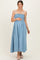 woman wearing a light blue maternity dress with smocked bodice and a visible baby bump