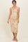 woman wearing a strapless floral maternity dress with ruching, showcasing her baby bump