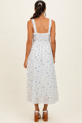 woman wearing a white floral midi dress with a fitted bodice and adjustable straps