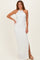 woman wearing a white halter neck maxi dress with textured details and a side slit