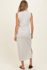 woman wearing a light gray sleeveless maternity maxi dress with a side slit and back view visible