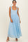 woman wearing a light blue maxi dress with tie straps and a flowy skirt
