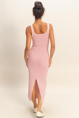 woman wearing a red and white striped sleeveless maxi dress with a side slit, viewed from the back