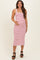 woman wearing a red and white striped maternity tank dress and holding her baby bump