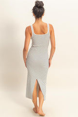 woman wearing a black and white striped maxi dress with a side slit and a square neckline