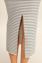 white and black striped midi skirt with a front slit detail, worn by a model showcasing the hemline