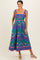 woman wearing a vibrant blue and pink patterned maxi dress with square neckline and pockets