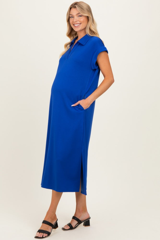 woman wearing a bright blue maternity dress with short sleeves and pockets, showing her baby bump