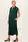woman wearing a dark green maternity polo dress with side slits and pockets, showcasing her baby bump
