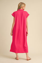 woman wearing a loose-fitting bright pink maxi dress with short sleeves, shown from the back
