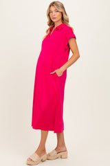 woman wearing a bright pink maternity dress with a collar and pockets, showcasing her baby bump