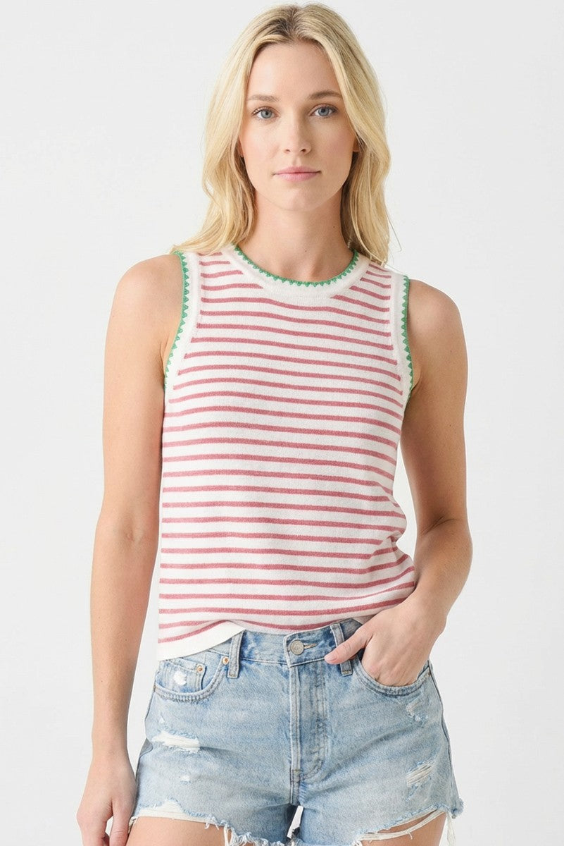 woman wearing a red and white striped sleeveless top with green trim and distressed denim shorts