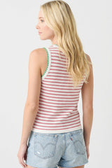 woman wearing a red and white striped sleeveless top with green trim, paired with denim shorts