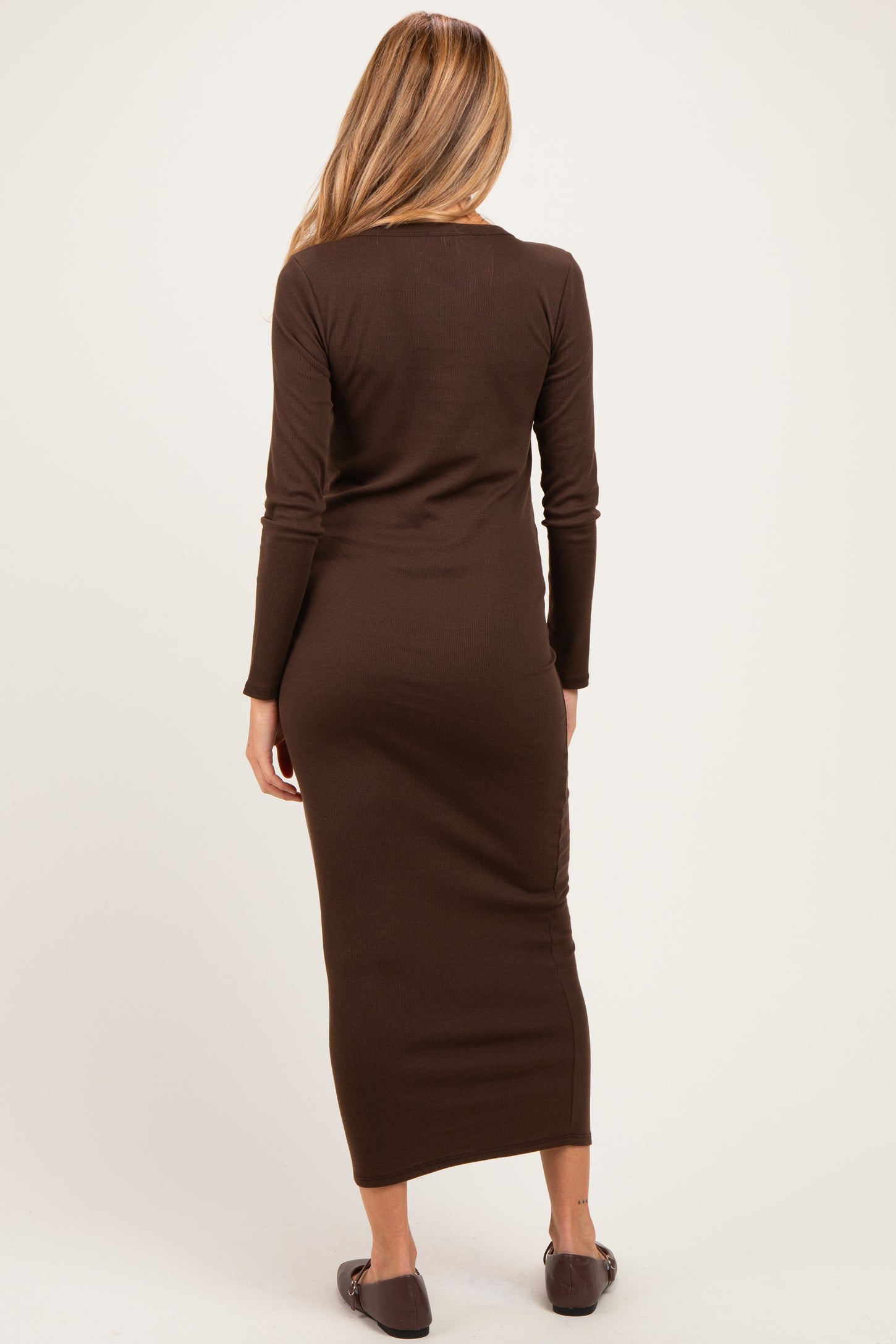 woman wearing a brown long sleeve maternity maxi dress, view from the back