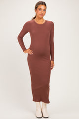 woman wearing a brown long sleeve maternity dress with a fitted silhouette and visible baby bump