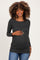 woman wearing a dark gray long sleeve maternity top with ruching and holding her baby bump