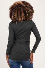 woman wearing a dark gray maternity top with side ruching, viewed from the back