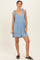 woman wearing a light blue sleeveless romper with tie straps and a cinched waist