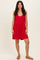 woman wearing a red sleeveless romper with a flowy bottom and a scoop neckline