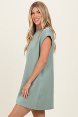 woman wearing a short sleeve mint green casual dress with a relaxed fit and round neckline