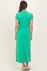 woman wearing a green maternity maxi dress with short sleeves, visible baby bump from the back