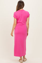 woman wearing a bright pink maternity maxi dress with short sleeves and a fitted silhouette