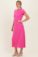 woman wearing a bright pink short sleeve maxi dress with a relaxed fit and side slits