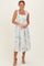 woman wearing a white floral midi dress with smocked bodice and tie straps