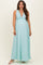 woman wearing a light blue sleeveless maternity maxi dress with a deep v-neck and empire waist, showcasing her baby bump