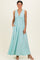 woman wearing a mint green maxi dress with a deep V-neck and side pockets