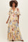 woman wearing a yellow floral maternity maxi dress with short sleeves and a V-neckline, showcasing her baby bump