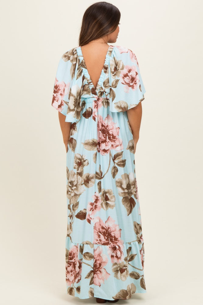 woman wearing a light blue floral maternity maxi dress with flutter sleeves and a deep v-back