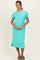 woman wearing a turquoise short sleeve midi dress with a pocket and side slits