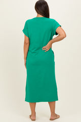 woman wearing a green maternity dress with short sleeves and a relaxed fit, showing off a baby bump from behind