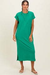 woman wearing a green short sleeve maxi dress with a pocket and side slits