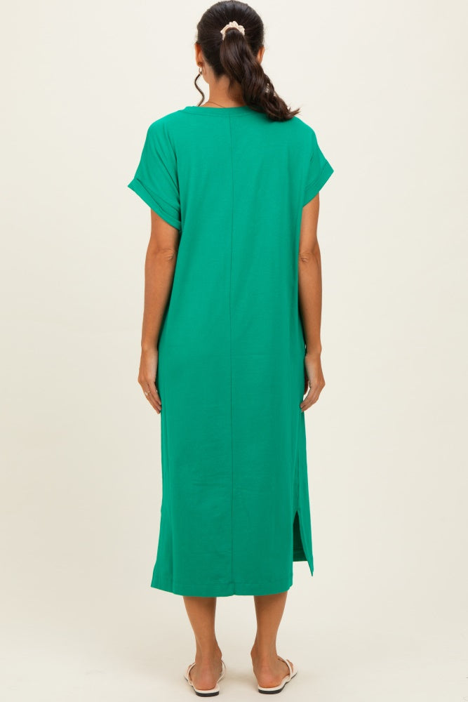 woman wearing a green midi dress with short sleeves and side slits, viewed from the back