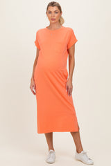 woman wearing an orange maternity t-shirt dress with a pocket and side slits, showing her baby bump