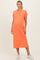 woman wearing an orange maternity t-shirt dress with a pocket and side slits, showing her baby bump