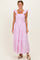 woman wearing a pink and white striped maxi dress with ruffle sleeves and a tiered skirt