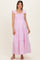 woman wearing a pink and white striped maternity maxi dress with ruffles and a tiered skirt, showing her baby bump